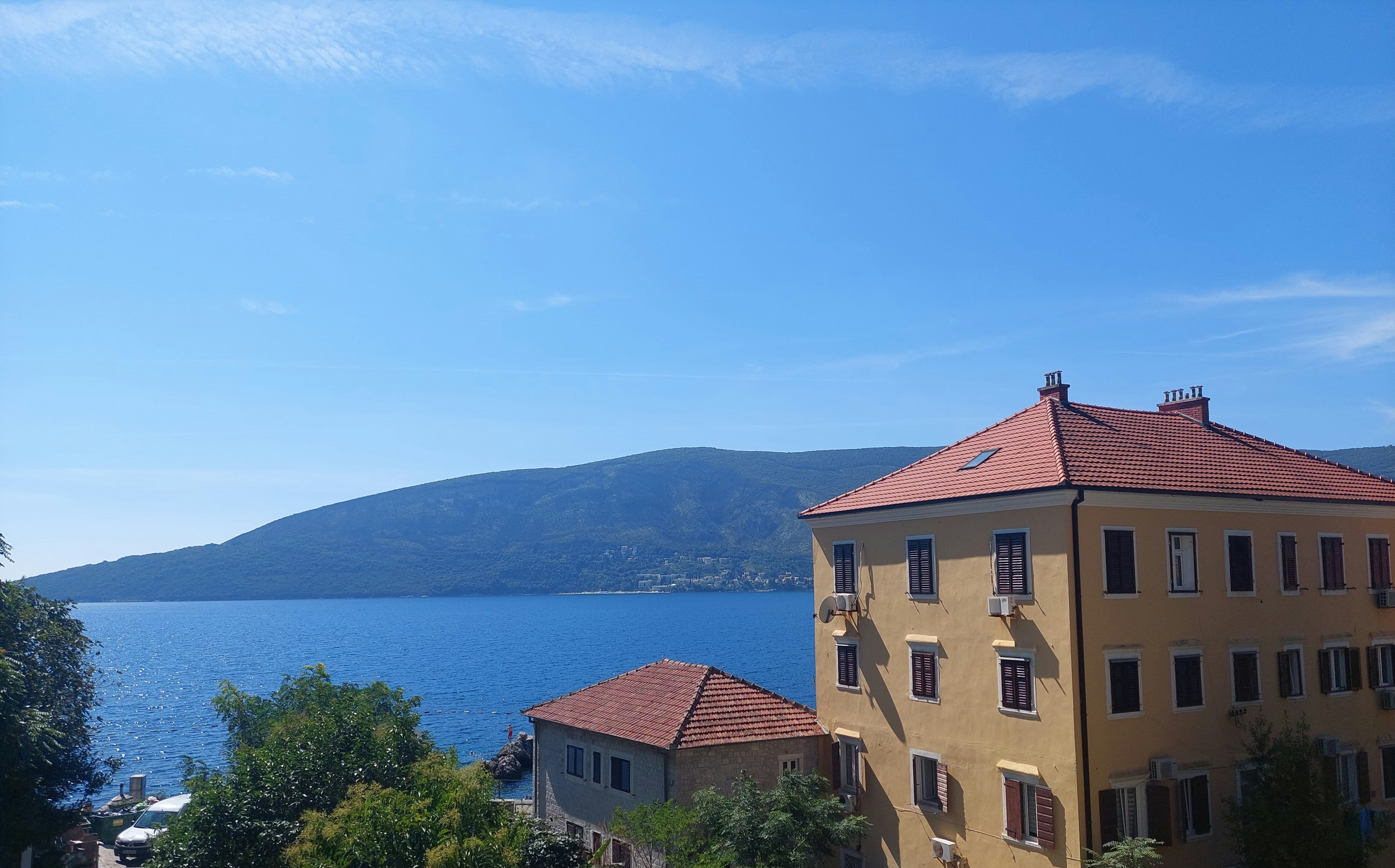 a view of a building with a lake in the background