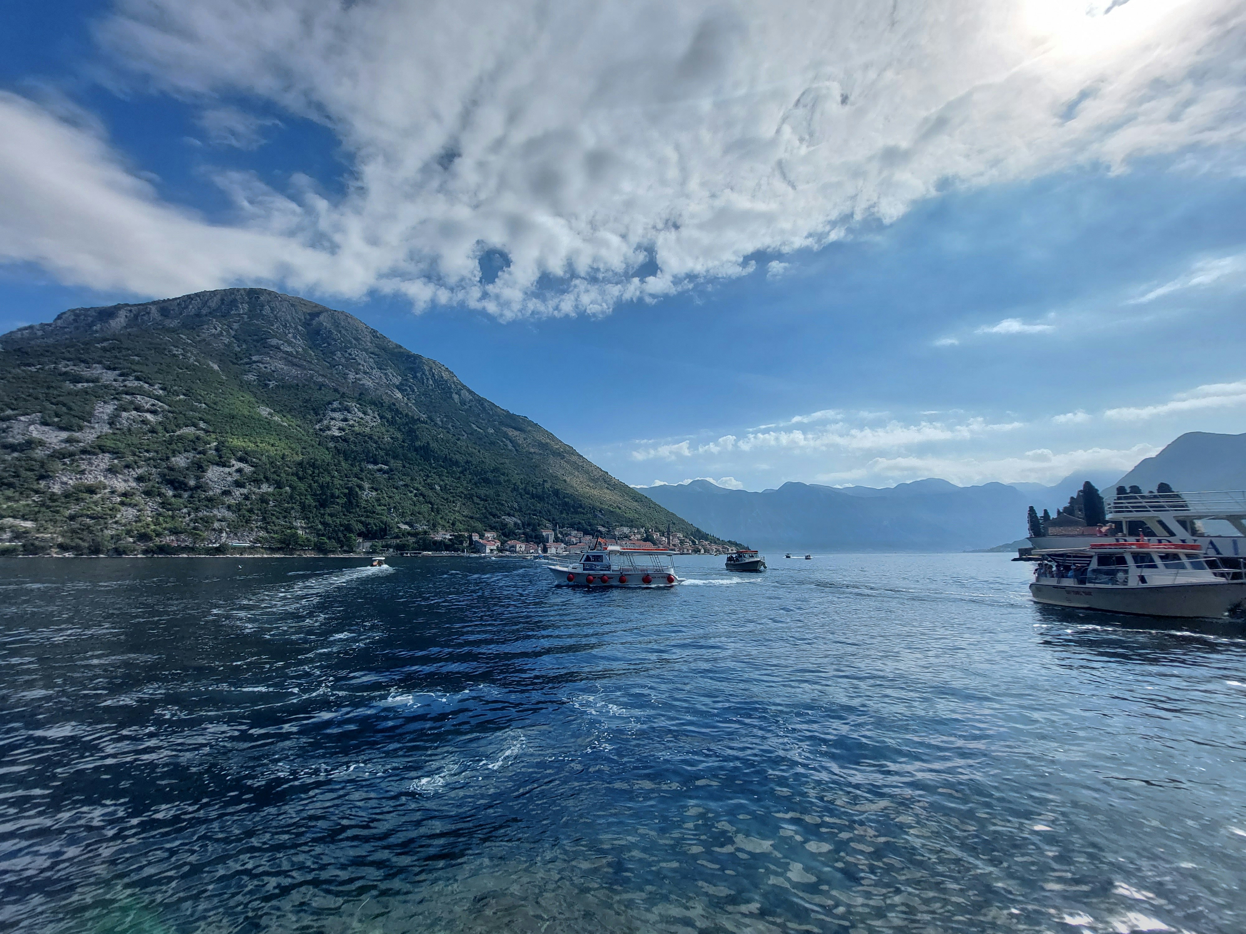 a group of boats floating on top of a body of water, 