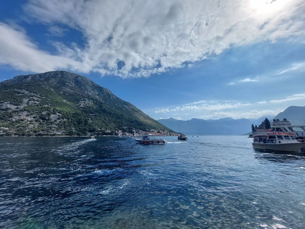 a group of boats floating on top of a body of water