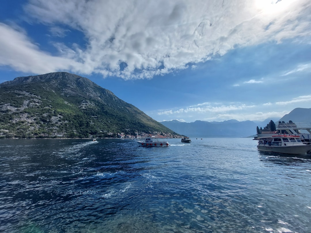 a group of boats floating on top of a body of water,