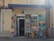 The image depicts the exterior of an art atelier gallery featuring an assortment of framed paintings displayed around the entrance. The artwork varies in style, including portraits, landscapes, and abstract pieces. A blue awning hangs above the door, and a sign prohibits photos and videos.