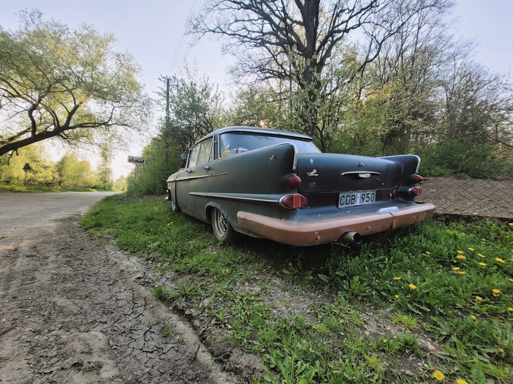 an old car parked on the side of the road