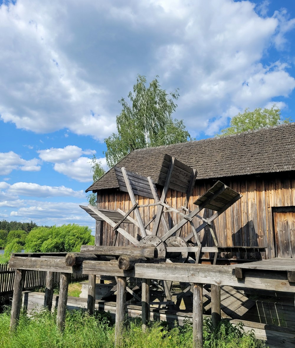 an old wooden building with a windmill on top of it