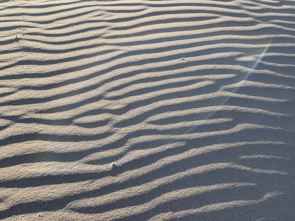 the sun shines on the sand of a beach