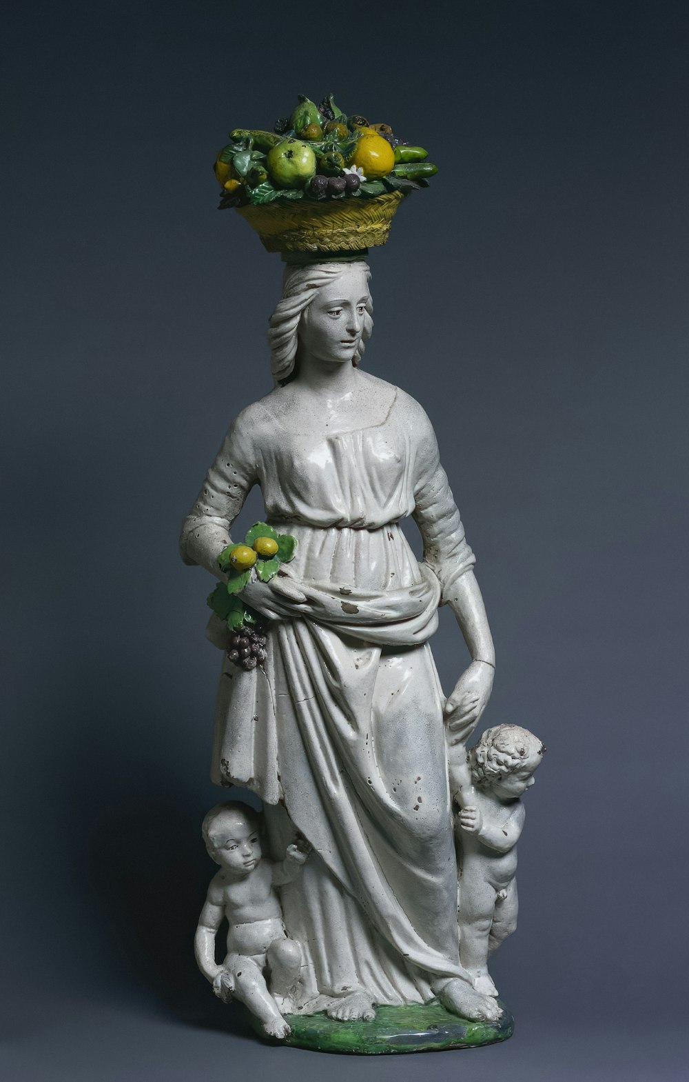 a statue of a woman with fruit on her head