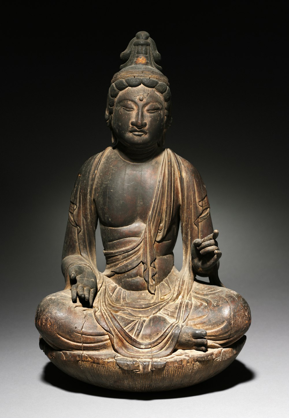 a buddha statue sitting on top of a table