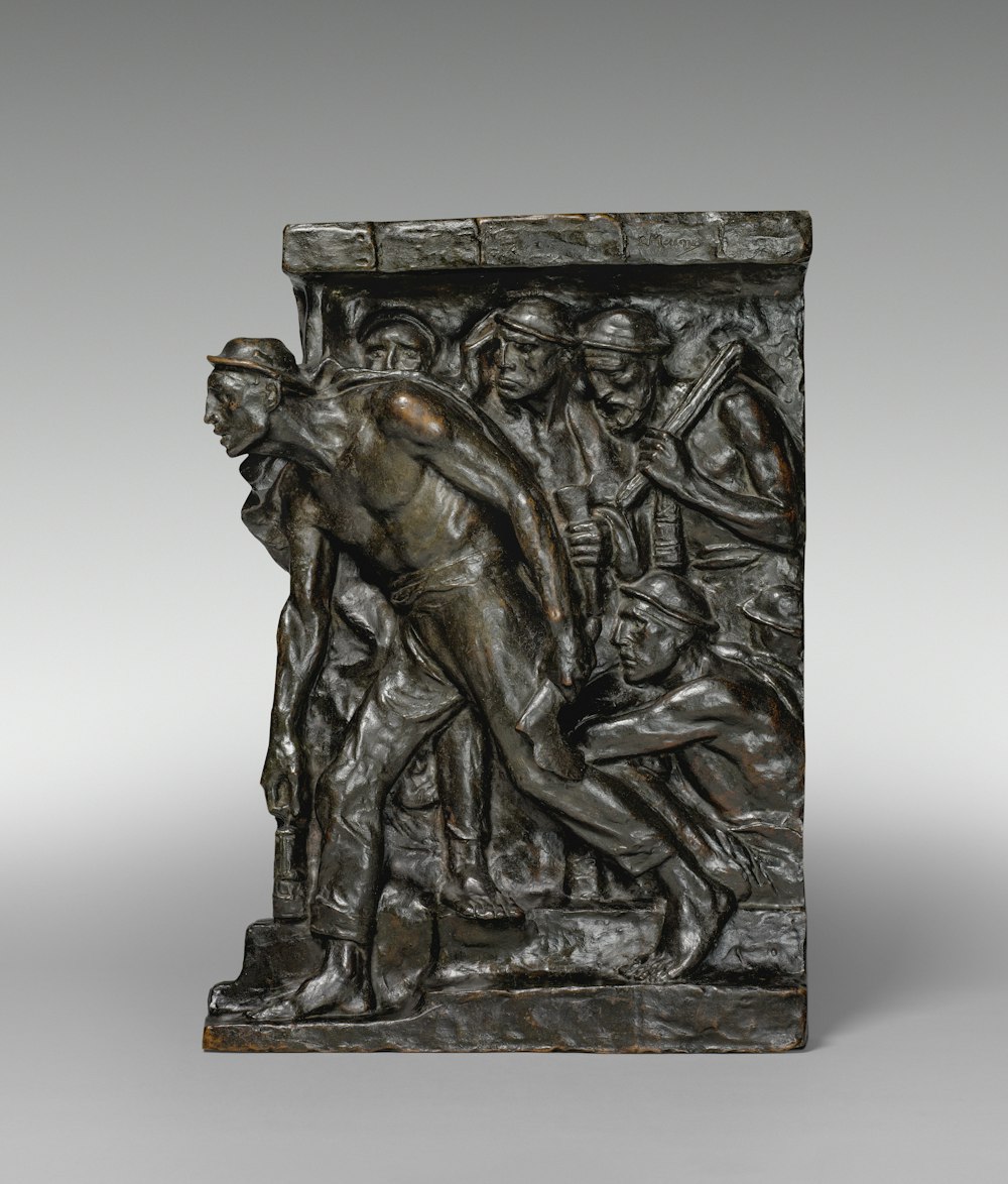 a bronze sculpture of a man holding a woman