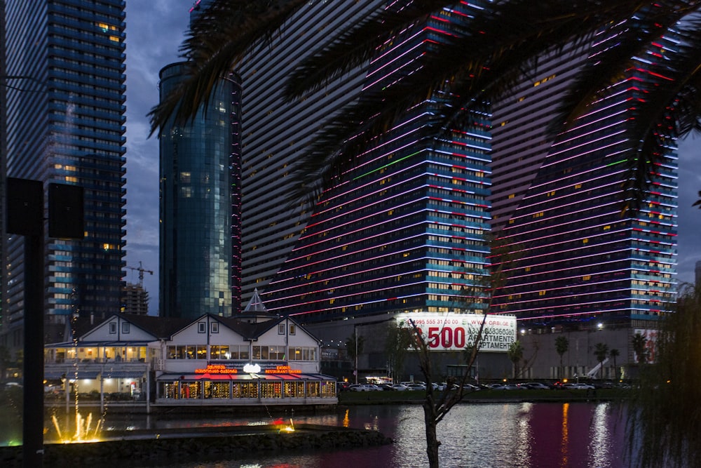 a city with tall buildings next to a body of water