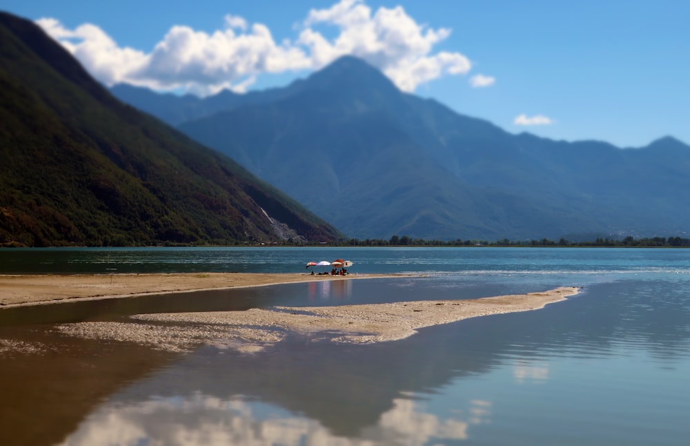 a boat on a lake with mountains in the background