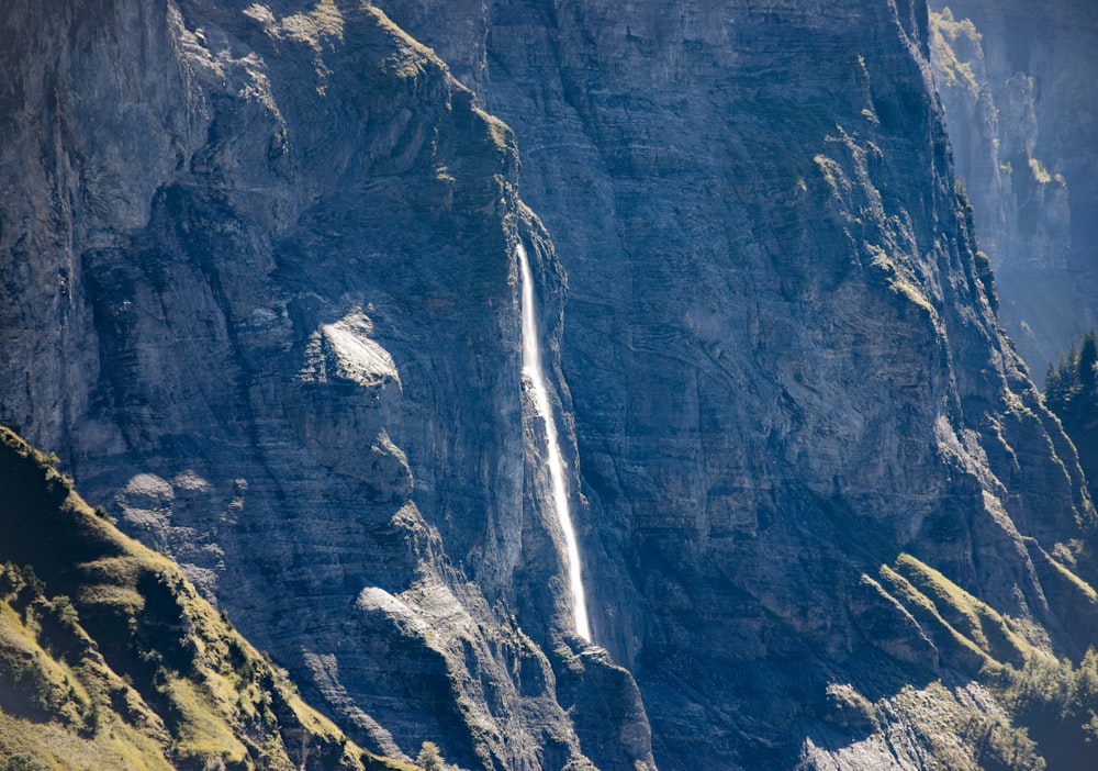 a waterfall cascading into the side of a mountain