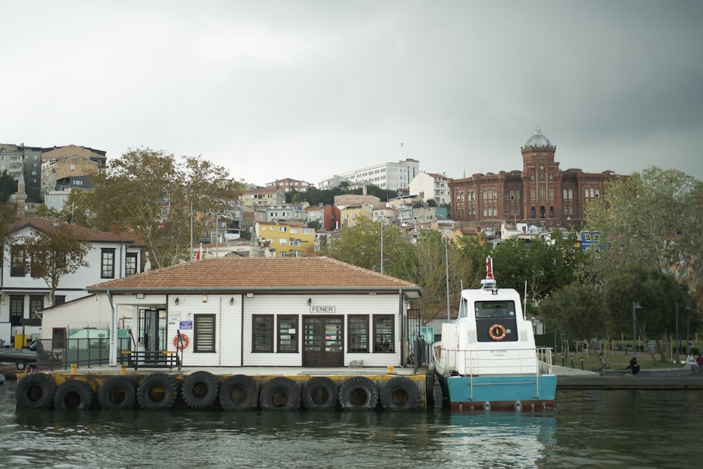 a boat docked at a dock in front of a city