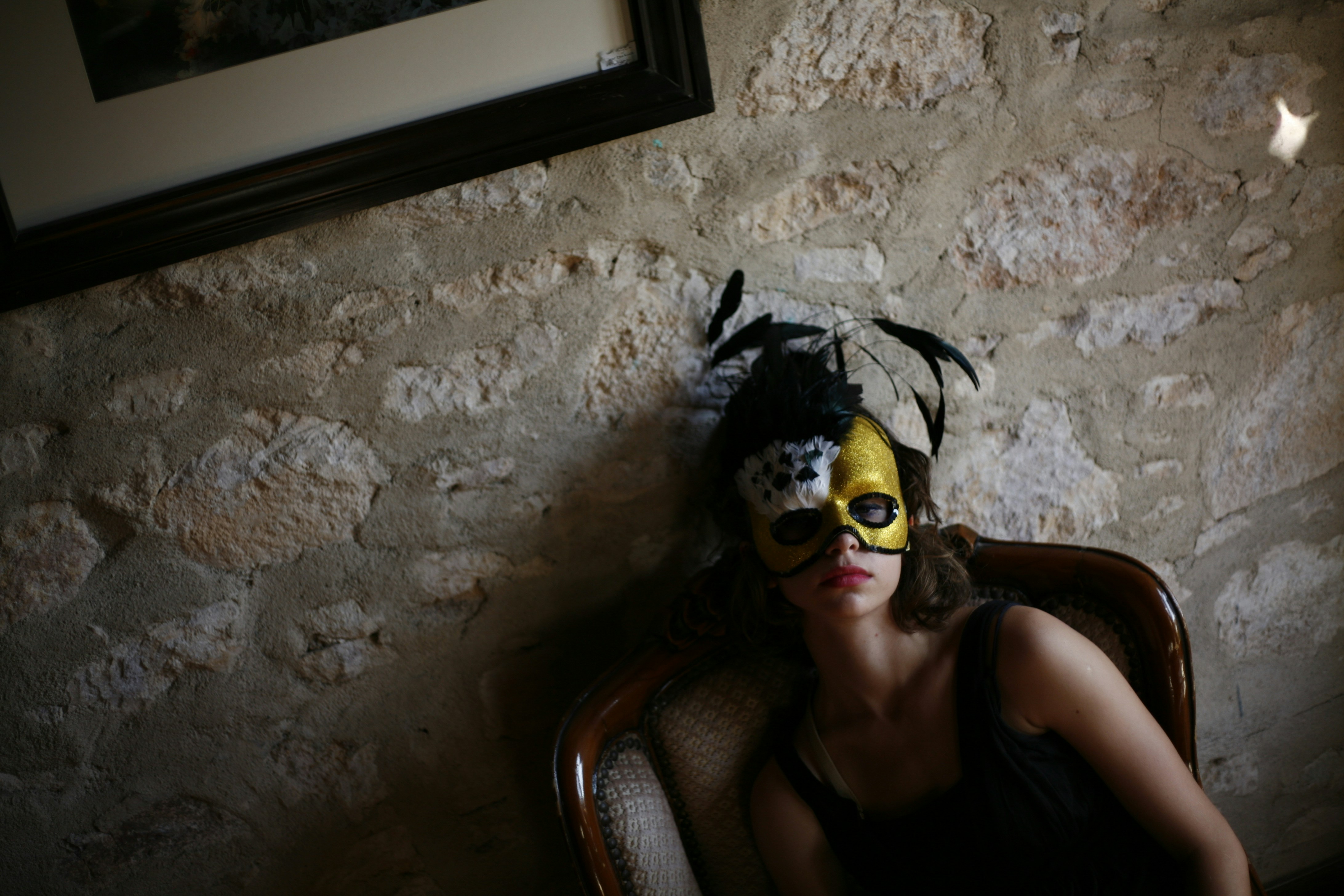 a woman sitting in a chair wearing a mask