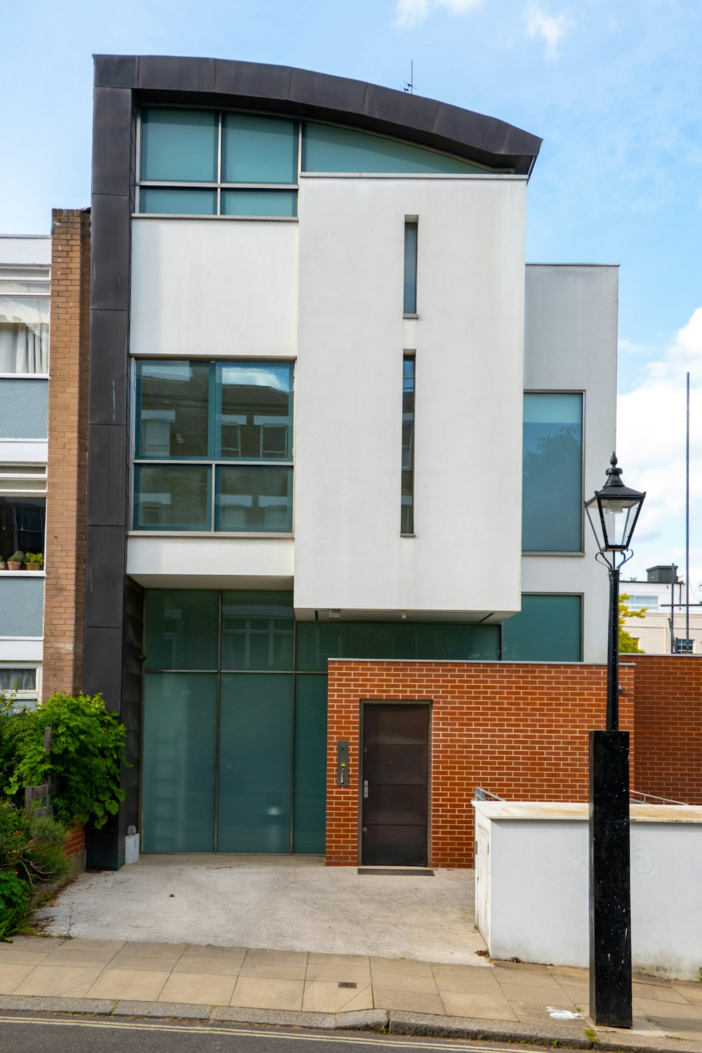 a tall white building sitting next to a street light