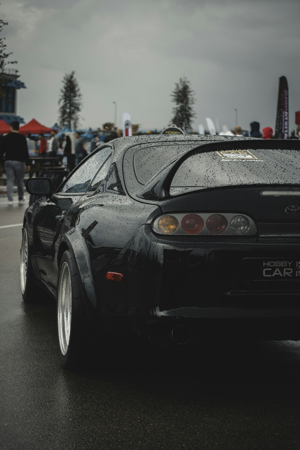 a black sports car driving down a street