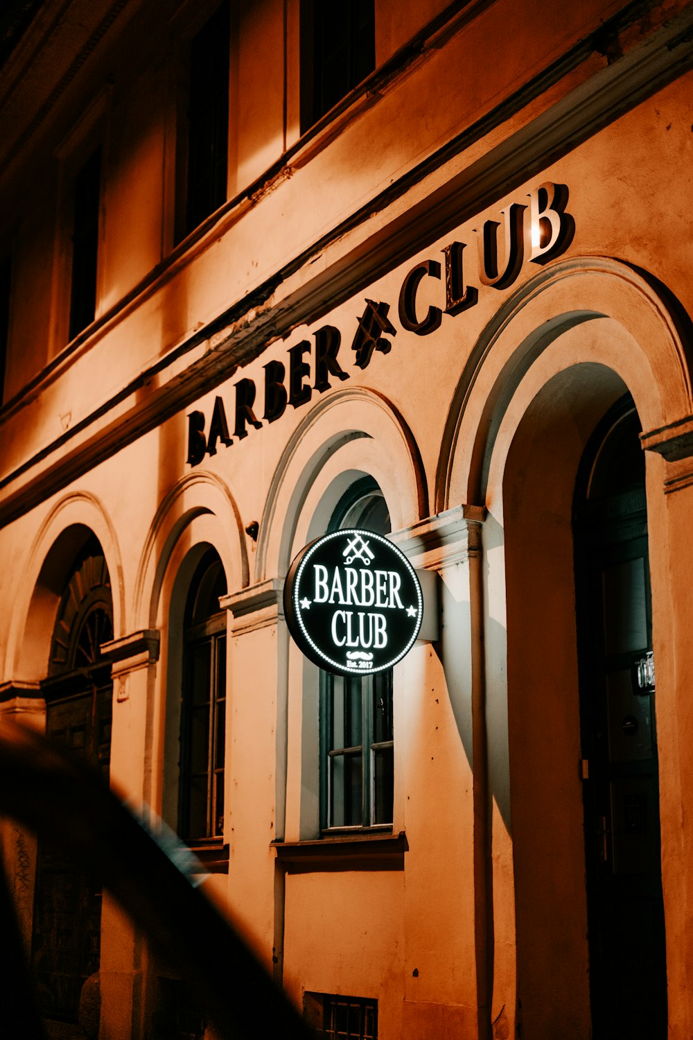 a building with a sign that reads barber club