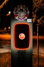 A sleek electric vehicle charging station glowing softly at dusk.