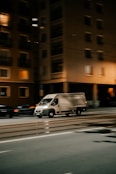a van driving down a street at night