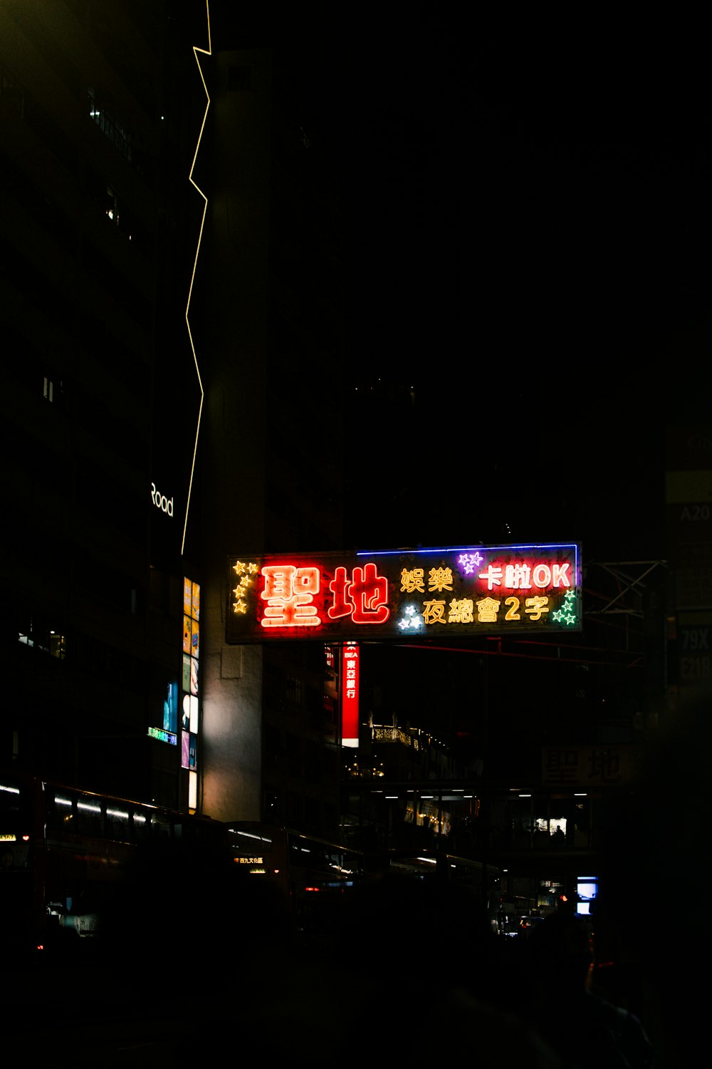 a street sign lit up at night in a city