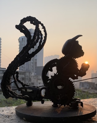 A silhouette of gears merged subtly with the rising sun over a horizon.