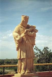 a statue of a man holding a book