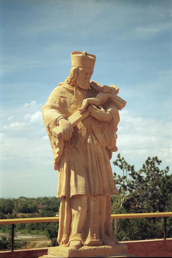 a statue of a man holding a book