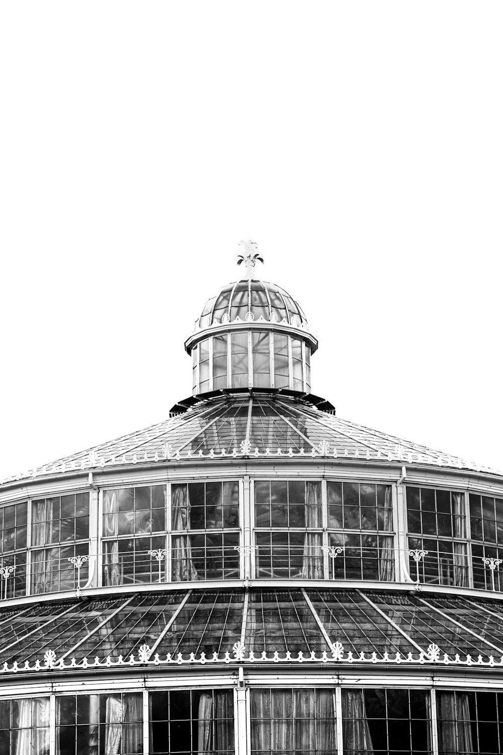 a black and white photo of a glass building