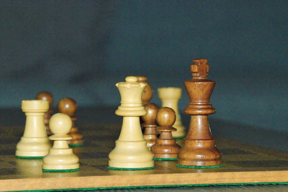 a wooden chess board with pieces on it