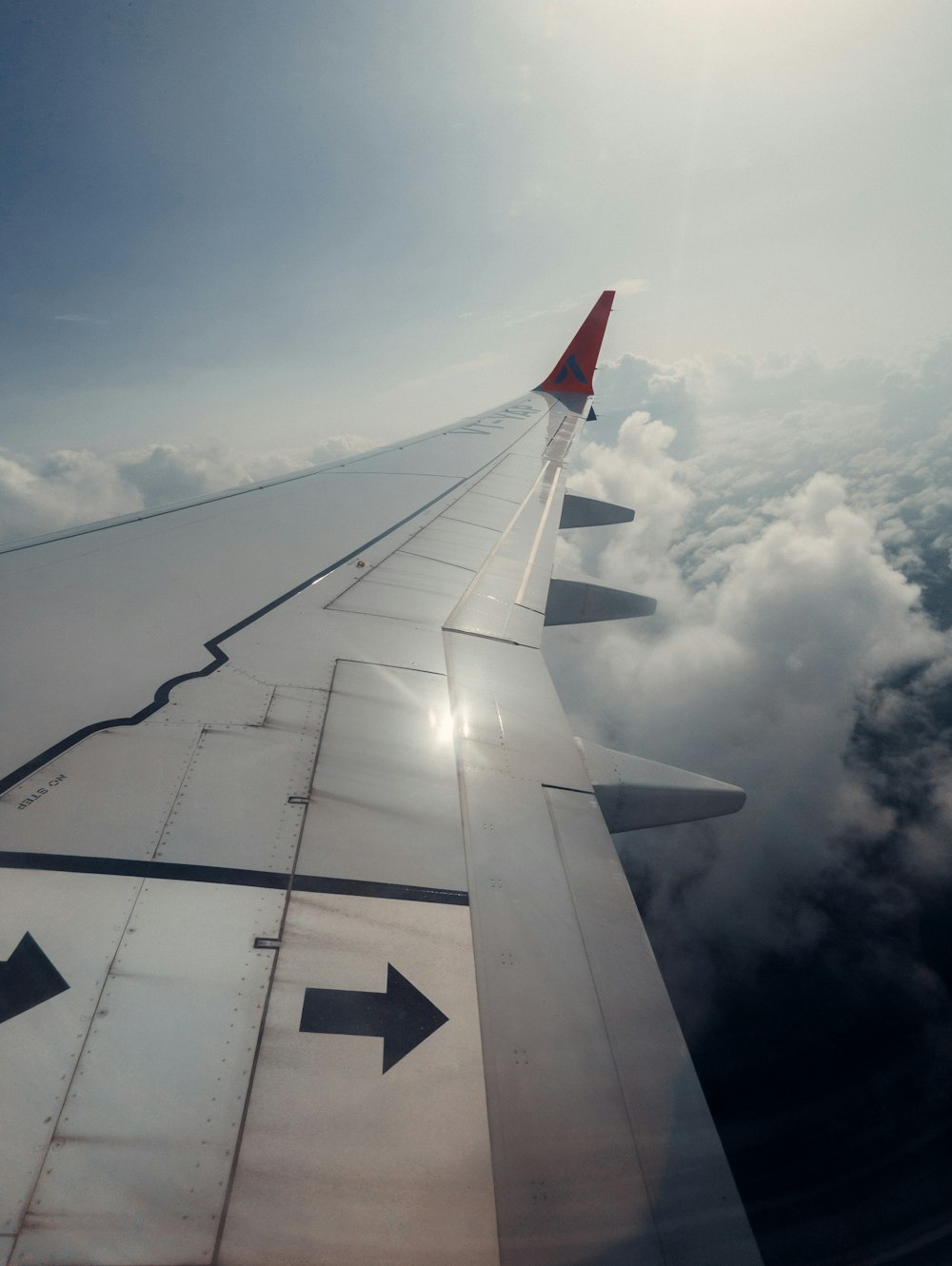 the wing of an airplane flying above the clouds