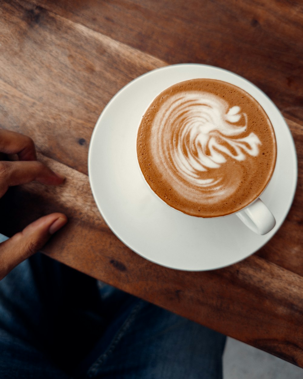 a cup of coffee on a wooden table