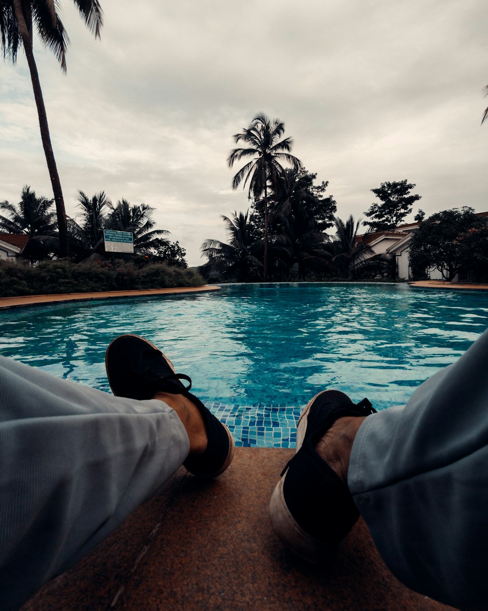 a person sitting in front of a swimming pool