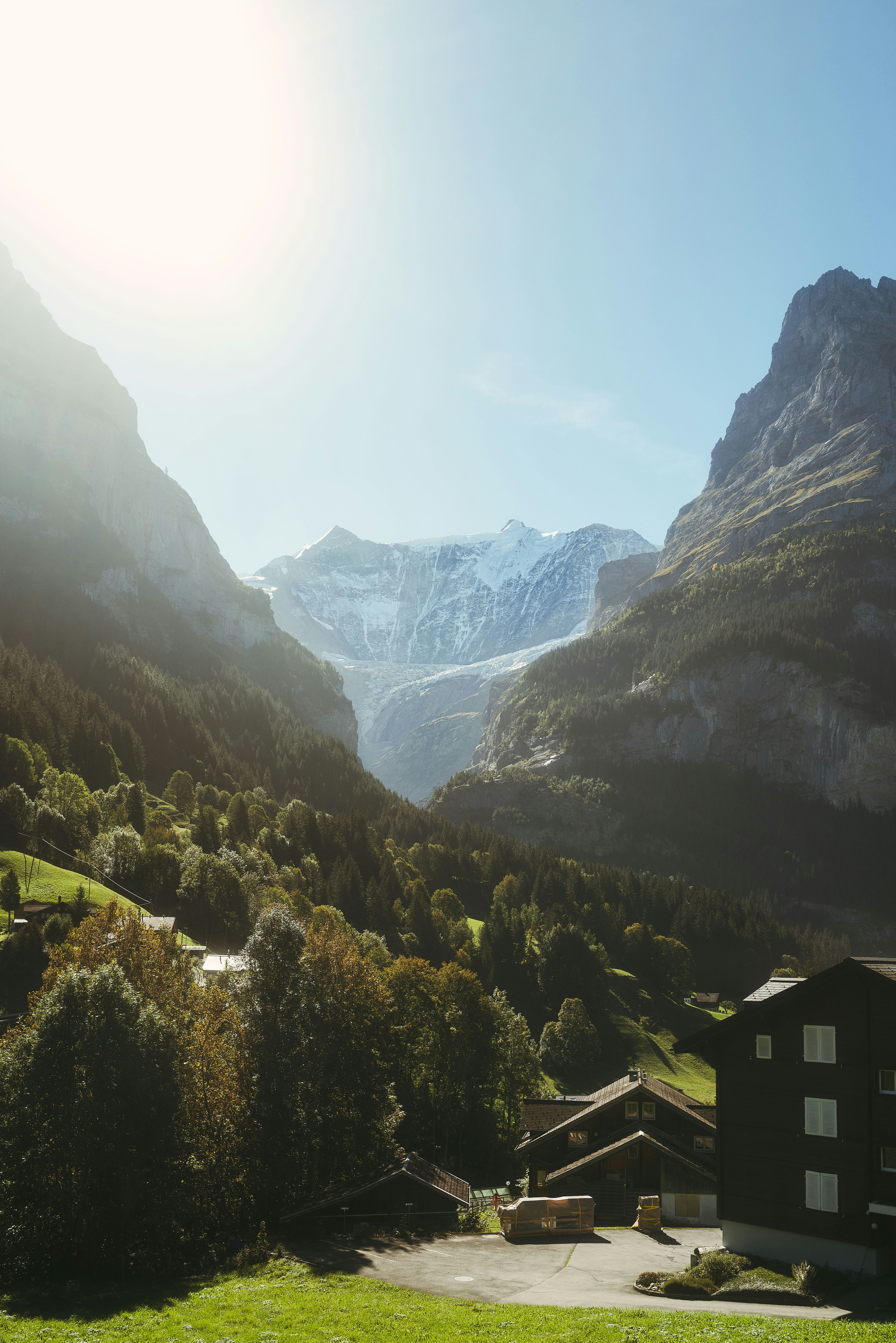 a view of a mountain range with houses in the foreground