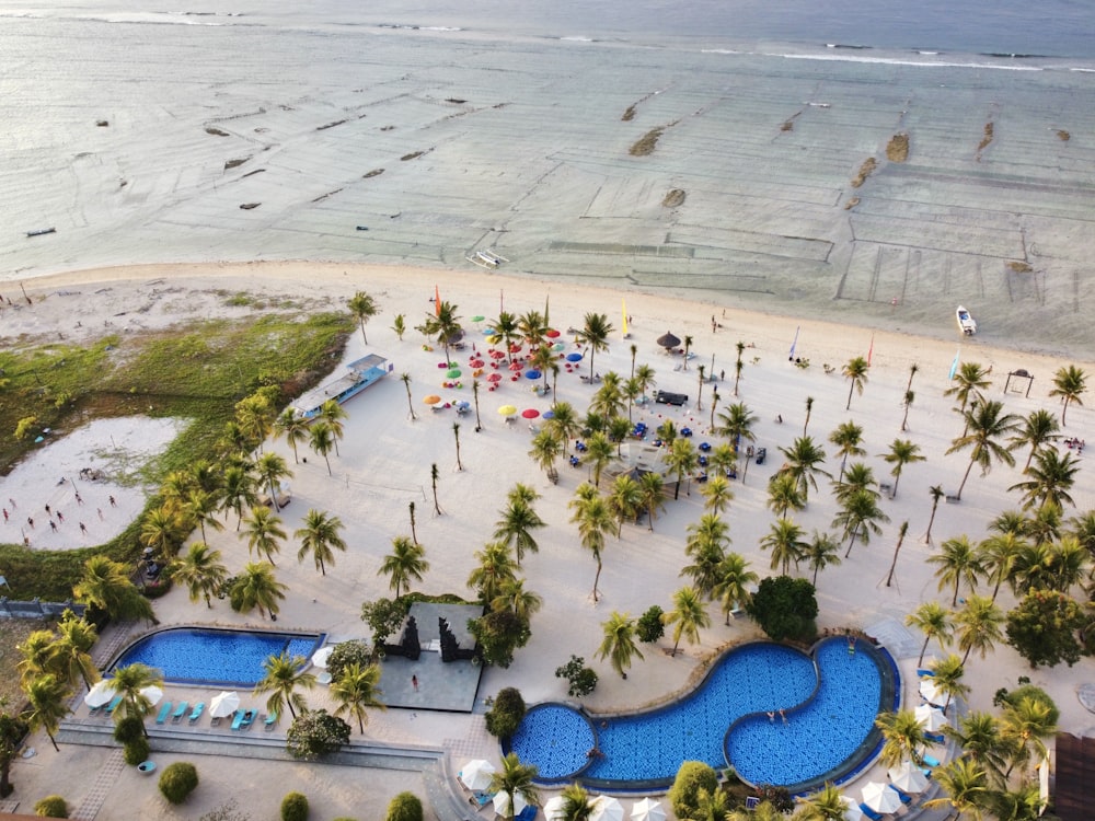 an aerial view of a beach resort with a pool