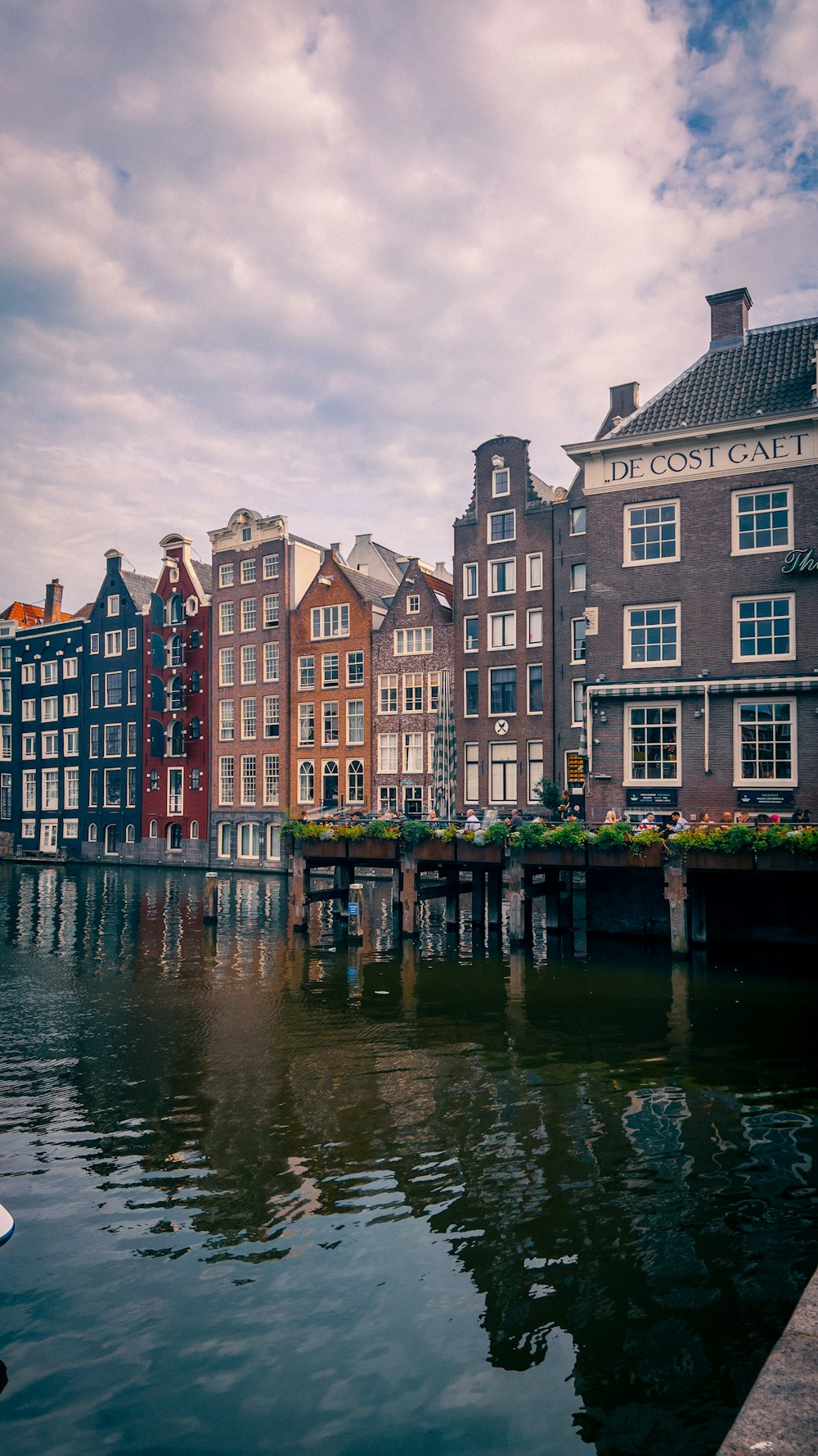 a body of water next to a row of buildings