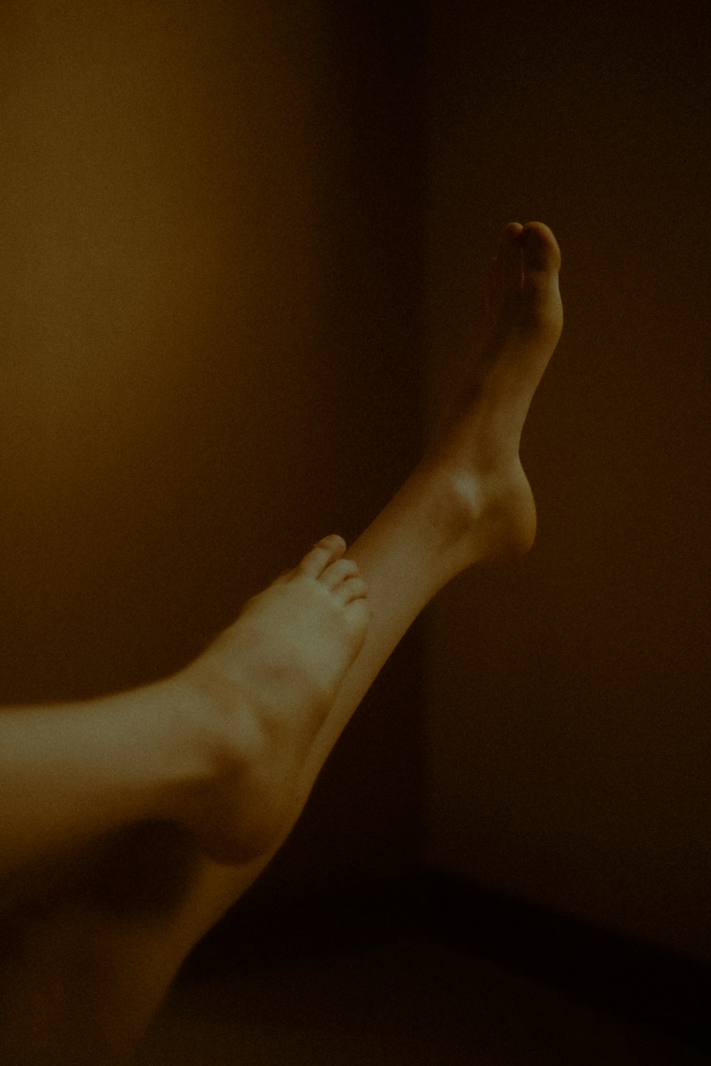 a person's bare feet in a dark room