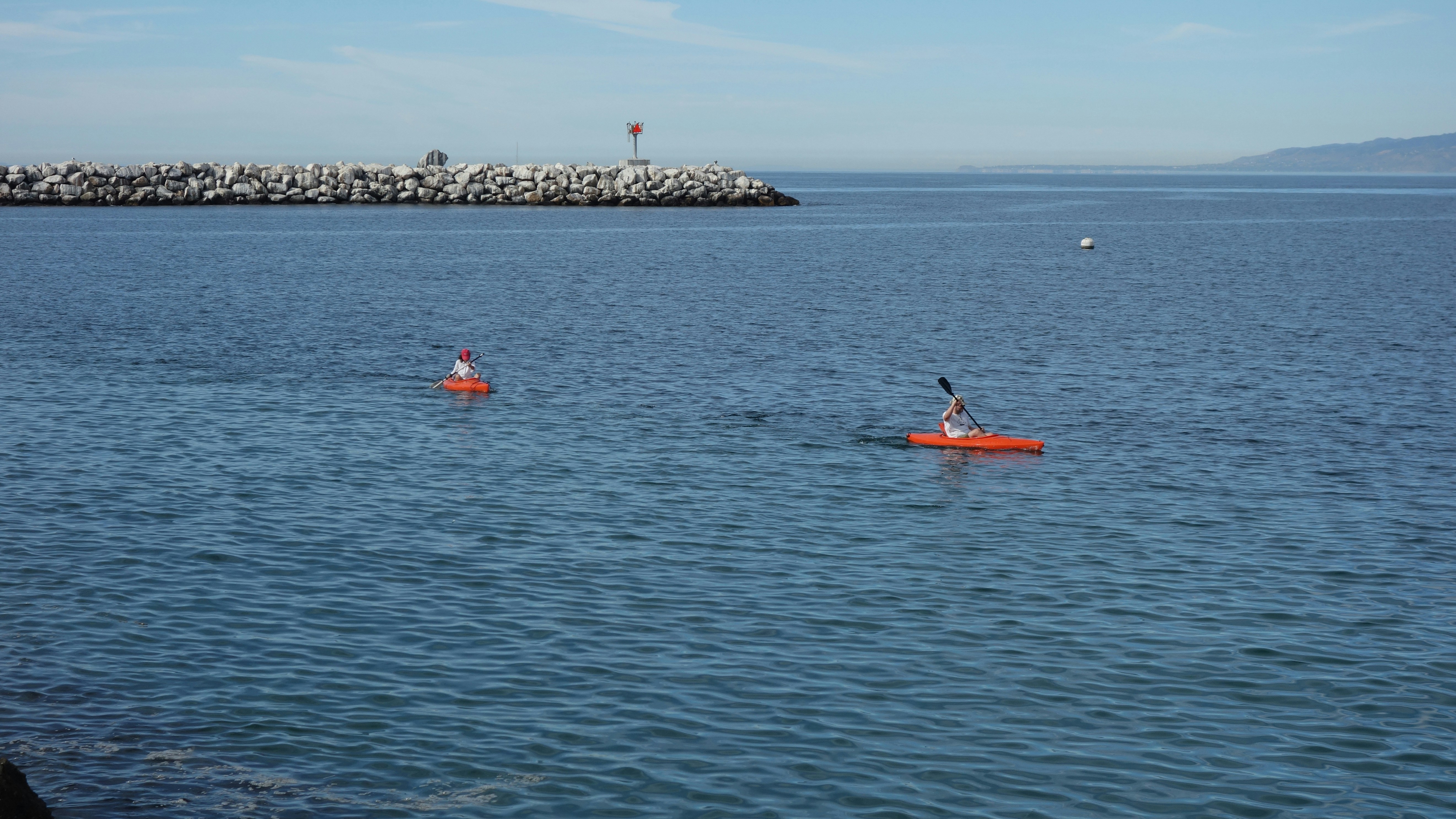 a couple of people in a kayak on a body of water