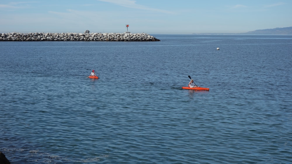 a couple of people in a kayak on a body of water