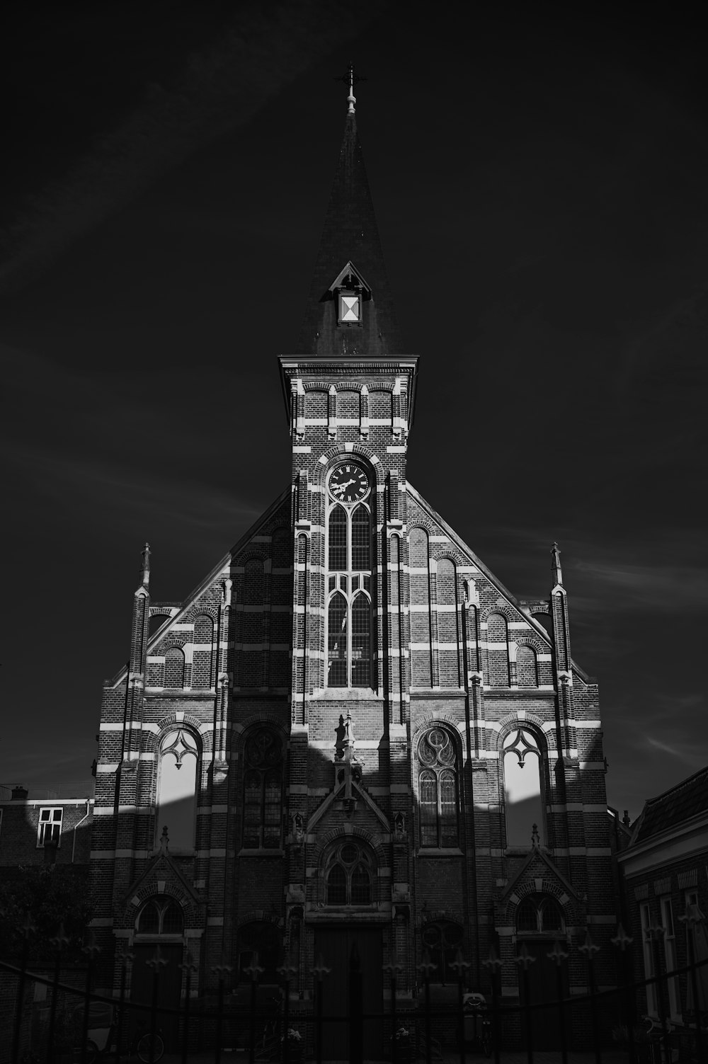 a black and white photo of a church at night