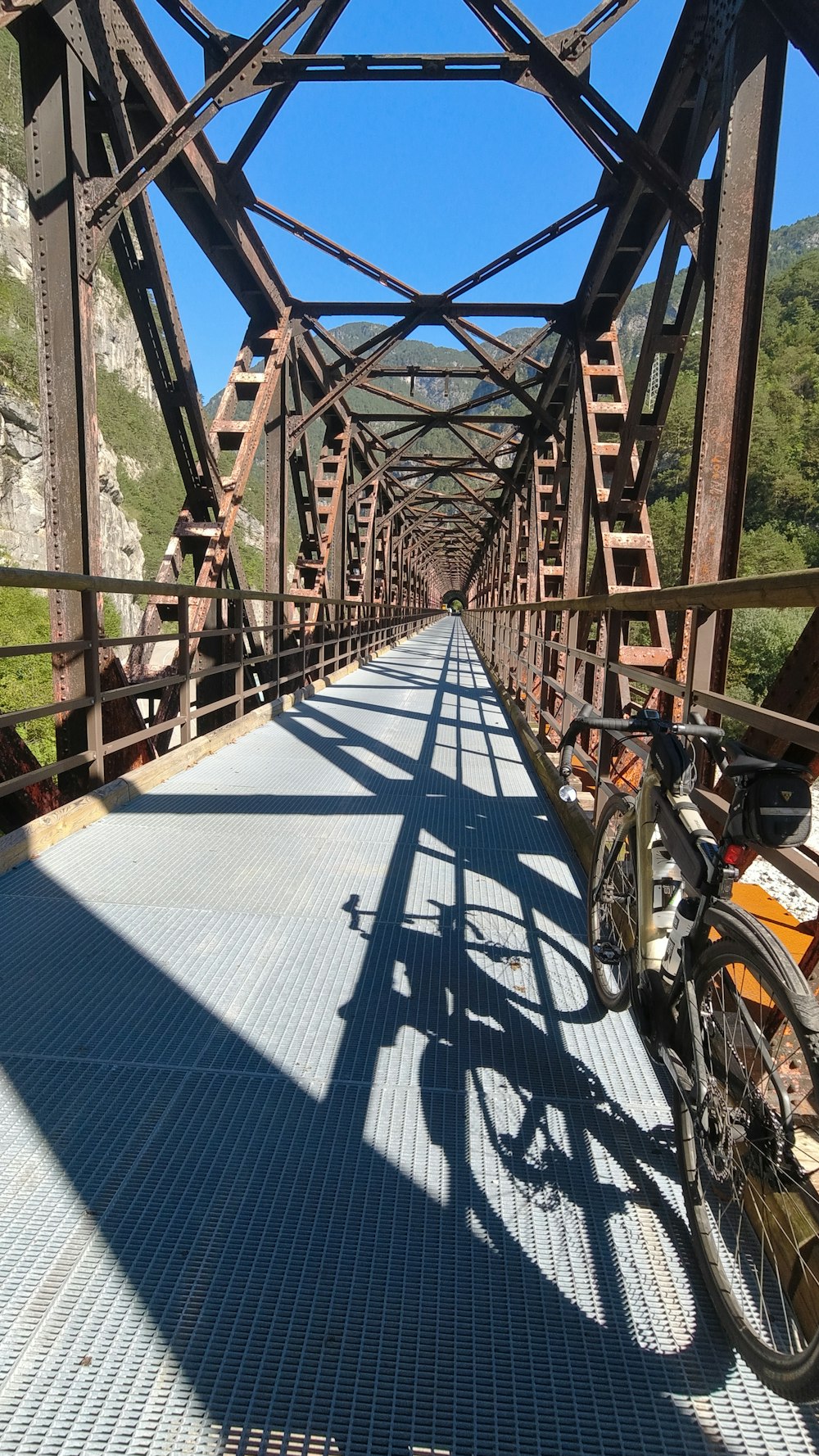 a bicycle is parked on a metal bridge