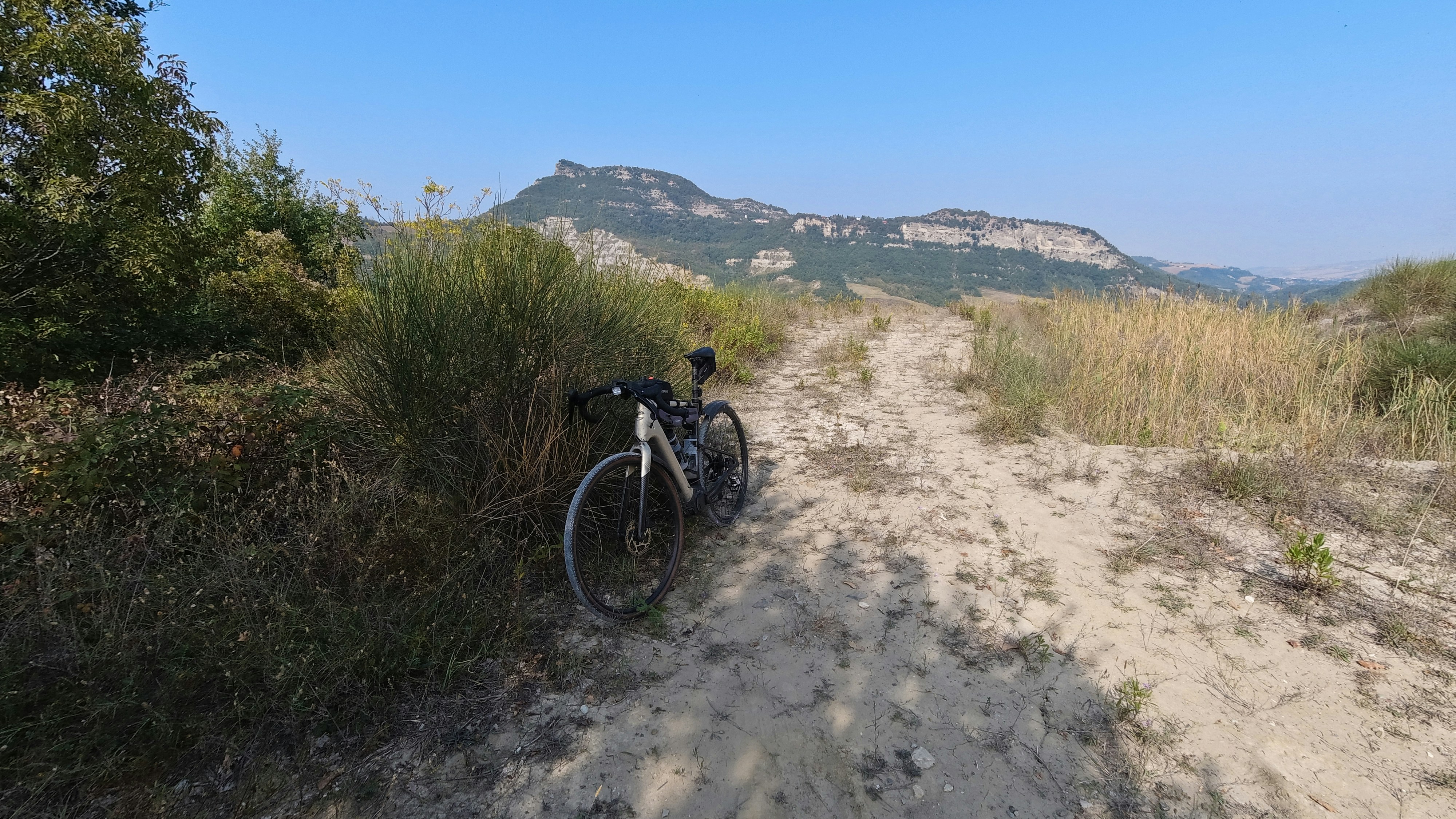 a bike is parked on a dirt road