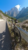 A sleek road bike parked against a scenic mountain backdrop.