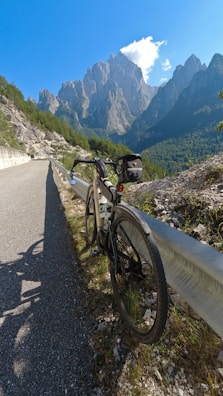 A sleek road bike parked against a scenic mountain backdrop.