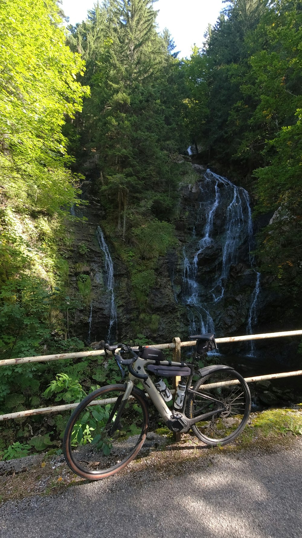 a bike is parked next to a waterfall
