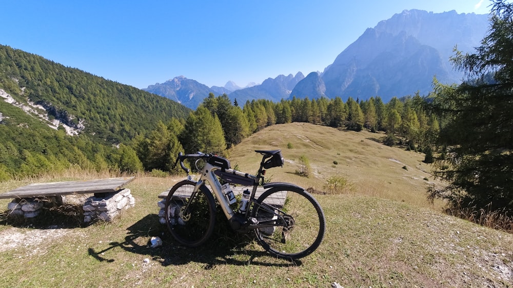 a bicycle is parked on the side of a hill