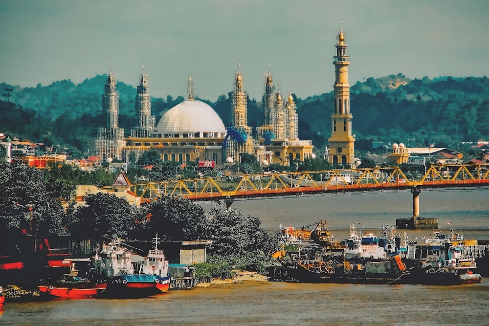 a bridge over a body of water with a city in the background