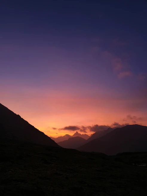 A serene mountain landscape at sunset, labeled with details about the location and time of day.