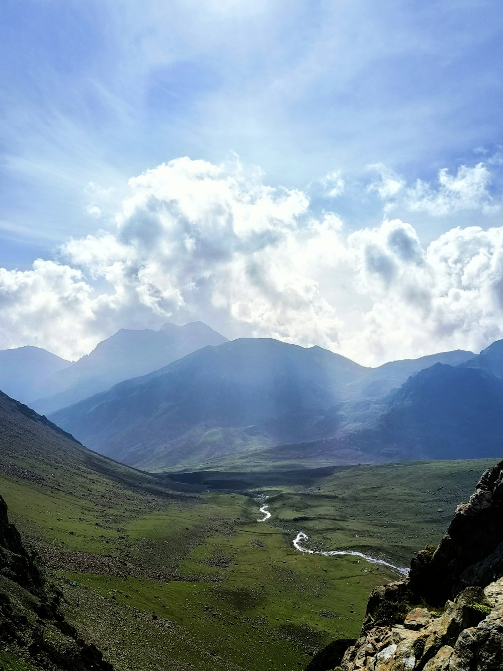 a view of a valley with mountains in the background