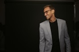 a man in a suit and glasses smiling