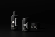 Luxury cosmetic products with sleek packaging in coral and black, set against a clean white backdrop.