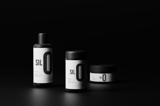 three bottles of silo on a black background