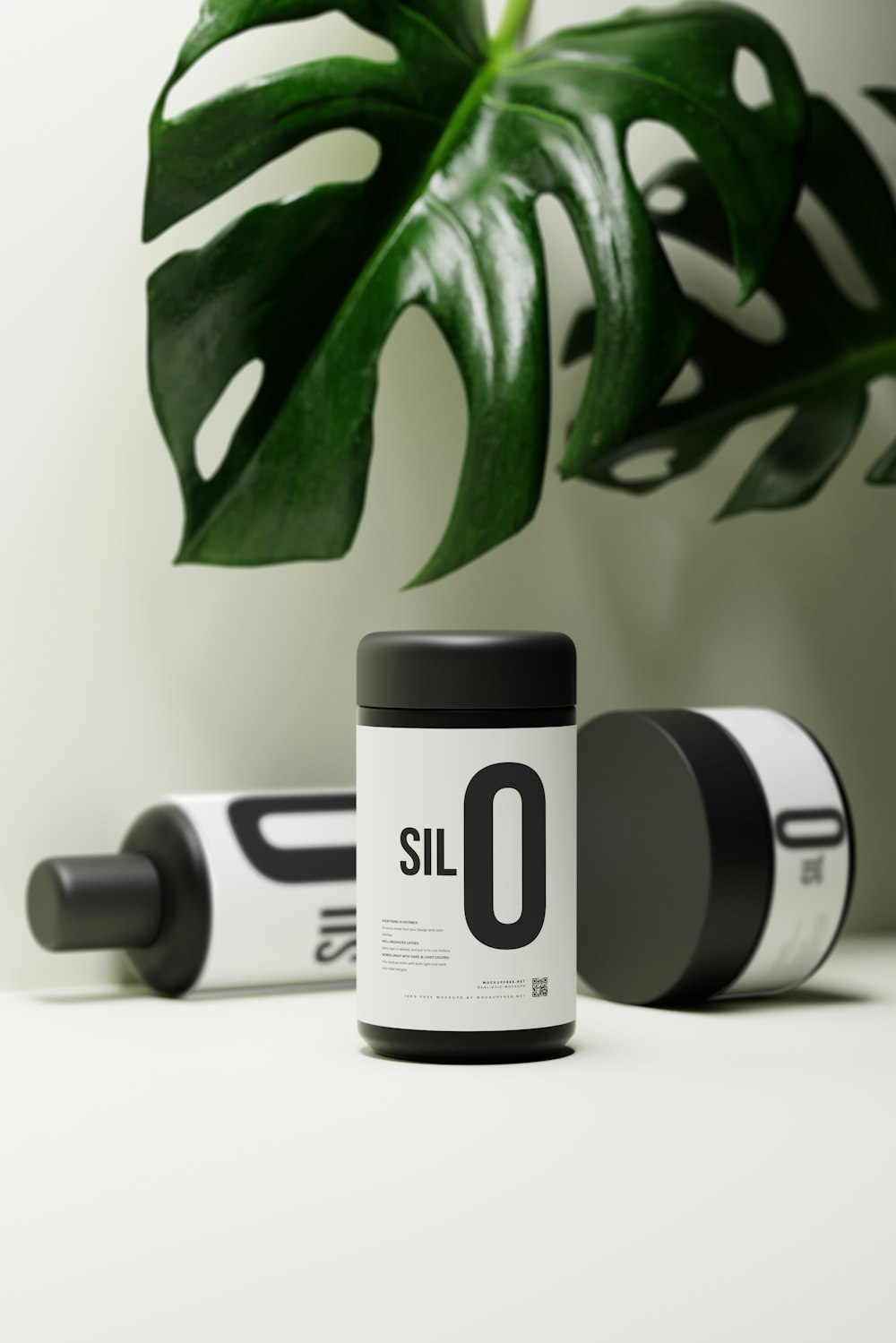 a bottle of sil 0 on a table next to a plant